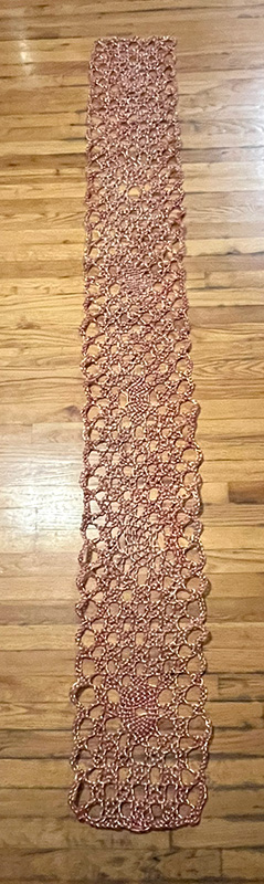 Finished piece of lace laid on the ground. 