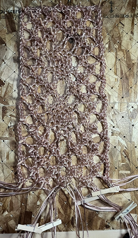 Working the bobbin lace pattern in speaker wire. Mostly complete.