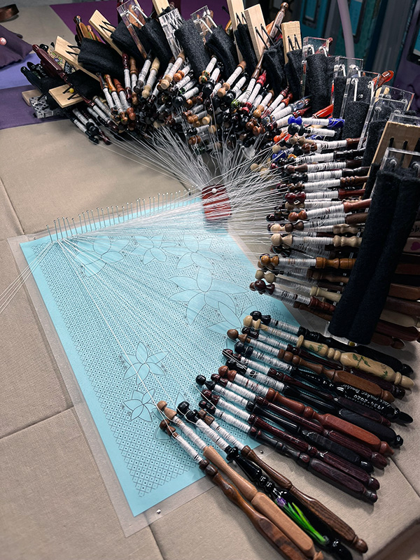 Beginning Utopia with 288 bobbins arranged around a lace pillow.