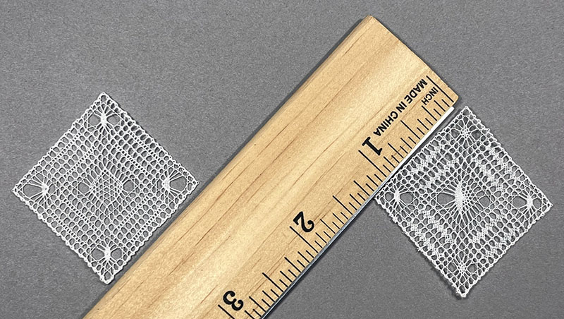 Ethereal and Gossamer micro bobbin lace artworks beside a ruler for scale.