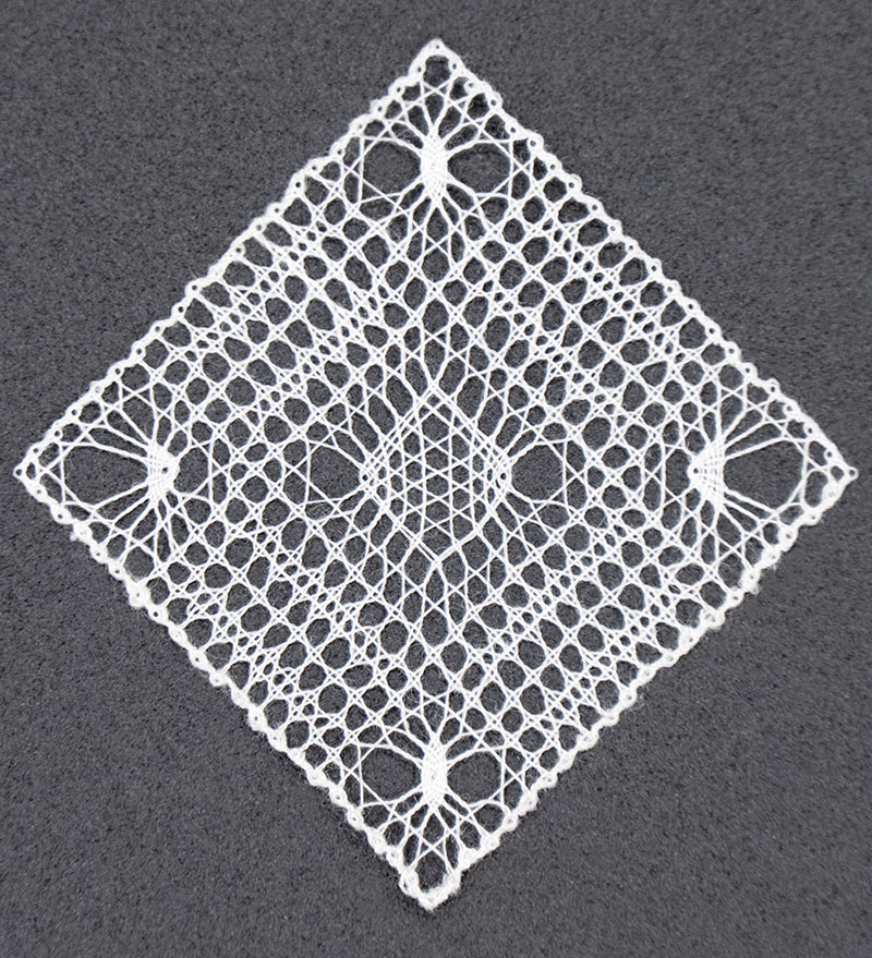 Ethereal micro bobbin lace artwork measuring 1.25 inches square.
