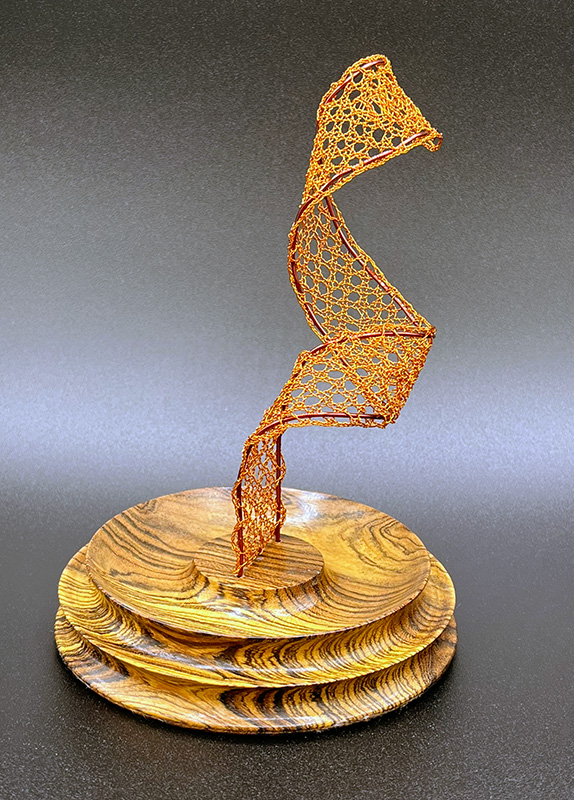 View 2 of bobbin lace sculpture with a wooden base.